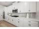 Kitchen with a stainless steel microwave and oven with white cabinets, countertops and subway tile backsplash at 3265 Lions Ruby Ln, Atlanta, GA 30349