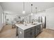 Bright, open kitchen with quartz countertops, island, stainless steel appliances, and an adjacent living room at 3265 Lions Ruby Ln, Atlanta, GA 30349