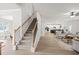 Spacious living room with a staircase, hardwood floors and open-concept design to the kitchen and dining areas at 3265 Lions Ruby Ln, Atlanta, GA 30349