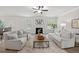 Comfortable living room showcases a fireplace, large windows, and a plush rug at 3265 Lions Ruby Ln, Atlanta, GA 30349