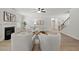 Open-concept living room with fireplace, hardwood floors, and access to the staircase and other rooms at 3265 Lions Ruby Ln, Atlanta, GA 30349