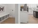 Mudroom area with storage bench and a partial view of the bright kitchen at 3265 Lions Ruby Ln, Atlanta, GA 30349