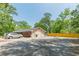 The home's garage is seen with a mural, plus a paved driveway and fenced yard at 5150 Scofield Rd, College Park, GA 30349