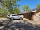 Brick home with a painted door and two cars parked in front of the building on a sunny day at 5150 Scofield Rd, College Park, GA 30349