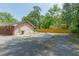 A detached garage with mural, ample parking space, and fenced yard at 5150 Scofield Rd, College Park, GA 30349