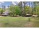 Overhead view of the wooded property highlighting the trees, lawns and outbuildings at 5655 Mccoy Rd Nw, Acworth, GA 30101