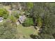 Aerial view showcasing the sprawling lot with fire pit and mature trees surrounding the home at 5655 Mccoy Rd Nw, Acworth, GA 30101