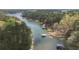 Expansive aerial view of a lake surrounded by dense green trees, featuring boat docks along the shoreline at 5655 Mccoy Rd Nw, Acworth, GA 30101