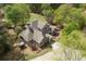 Aerial view of the home showcasing the manicured lawn, patio, and lush landscaping at 5655 Mccoy Rd Nw, Acworth, GA 30101