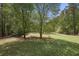 Expansive backyard with mature trees and landscaping, great for outdoor activities at 5655 Mccoy Rd Nw, Acworth, GA 30101