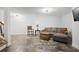 Finished basement with stone tile flooring, a comfortable couch, and stairs to the upper levels at 5655 Mccoy Rd Nw, Acworth, GA 30101