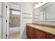 Neutral bathroom with a single vanity, built-in shower and tub combination, and a large framed mirror at 5655 Mccoy Rd Nw, Acworth, GA 30101