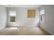Empty bedroom featuring neutral paint, windows that allow natural light, and neutral carpet at 5655 Mccoy Rd Nw, Acworth, GA 30101