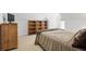 Bedroom with sloped ceiling, rustic wooden dresser and shelving, and a bed with comfortable brown bedding at 5655 Mccoy Rd Nw, Acworth, GA 30101