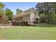 View of the two-story home with brick and siding, a two-car garage, and outdoor patio at 5655 Mccoy Rd Nw, Acworth, GA 30101