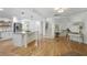 Bright, open kitchen with stainless steel appliances, marble island, and hardwood floors at 5655 Mccoy Rd Nw, Acworth, GA 30101