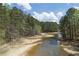Serene view of the private lake and lush, natural landscape surrounding the property at 5655 Mccoy Rd Nw, Acworth, GA 30101