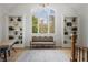 Bright living room featuring vaulted ceilings, built-in bookshelves, and a large window with natural light at 5655 Mccoy Rd Nw, Acworth, GA 30101