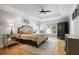 Well-lit main bedroom featuring hardwood floors, tray ceilings and a comfortable seating area at 5655 Mccoy Rd Nw, Acworth, GA 30101