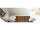 Cozy half bathroom featuring laminate floors, a pedestal sink, and a toilet with a sign on top at 11050 Skyway Dr, Duluth, GA 30097