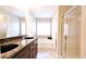 Bathroom featuring double sinks, granite countertops, and a separate shower and tub at 11050 Skyway Dr, Duluth, GA 30097