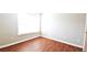 Bedroom featuring wood-look floors and a large window for natural light at 11050 Skyway Dr, Duluth, GA 30097