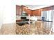 Modern kitchen with stainless steel appliances, granite countertops, and dark wood cabinets at 11050 Skyway Dr, Duluth, GA 30097