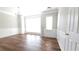 A bright living room featuring hardwood floors, modern wainscotting, and a stylish chandelier at 11050 Skyway Dr, Duluth, GA 30097