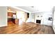 Open-concept living room with a fireplace, built-in shelves, and hardwood floors open to the kitchen at 11050 Skyway Dr, Duluth, GA 30097