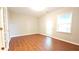 Spacious living area featuring wood-look floors, natural light, and an exterior door at 11050 Skyway Dr, Duluth, GA 30097