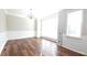 A bright living room featuring hardwood floors, modern wainscotting, and a stylish chandelier at 11050 Skyway Dr, Duluth, GA 30097