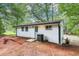 Home's backyard with some trees and a white exterior at 2457 Shiloh Dr, Decatur, GA 30034