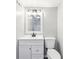 Bathroom featuring a white vanity, toilet, and sink with modern fixtures at 2457 Shiloh Dr, Decatur, GA 30034