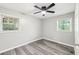 Bedroom with hardwood floors, windows, neutral paint, and a ceiling fan at 2457 Shiloh Dr, Decatur, GA 30034