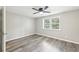 Bedroom with ceiling fan, hardwood floors, and a window at 2457 Shiloh Dr, Decatur, GA 30034