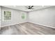 Serene bedroom with neutral walls, gray flooring, ceiling fan and bright windows at 2457 Shiloh Dr, Decatur, GA 30034