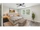 Bedroom virtually staged with neutral toned bed and furniture, and a ceiling fan at 2457 Shiloh Dr, Decatur, GA 30034