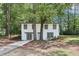 Charming two-story home nestled between mature trees and lush greenery at 2457 Shiloh Dr, Decatur, GA 30034