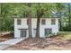 Charming two-story home nestled between mature trees and lush greenery at 2457 Shiloh Dr, Decatur, GA 30034