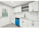 Modern kitchen featuring white cabinets, light countertops, and blue dishwasher at 2457 Shiloh Dr, Decatur, GA 30034