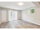 Bright living room with hardwood floors, window, and door to the backyard at 2457 Shiloh Dr, Decatur, GA 30034