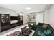 Living room staged with dark wood accents, a green couch, and a large area rug at 2457 Shiloh Dr, Decatur, GA 30034
