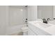 Bright bathroom features white fixtures, black hardware, and a shower over the tub at 3244 Lions Ruby Ln, Atlanta, GA 30349