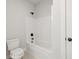 This bathroom features a toilet, bathtub, shower head, and a shower surround at 3244 Lions Ruby Ln, Atlanta, GA 30349