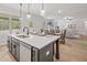 Bright open-concept kitchen features a large island, stainless steel appliances and a connected dining and living area at 3244 Lions Ruby Ln, Atlanta, GA 30349