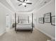 This spacious main bedroom features a tray ceiling, ceiling fan, and a four-poster bed at 3244 Lions Ruby Ln, Atlanta, GA 30349