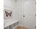 A stylish mudroom features a built-in bench with storage cubbies and decorative wall art at 3244 Lions Ruby Ln, Atlanta, GA 30349