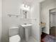 Clean, well-lit bathroom with pedestal sink, and neutral tile flooring at 3300 Old Mill Ct, Decatur, GA 30033