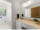 Bright bathroom with single sink vanity, large mirror, and natural light at 3300 Old Mill Ct, Decatur, GA 30033