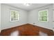 Bedroom with hardwood floors and natural light from two windows at 3300 Old Mill Ct, Decatur, GA 30033
